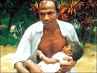 Mr Wijeratne breastfeeds his daughter