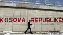 A pedestrian walks by a graffito reading 'Kosova Republic!' in the capital, Pristina (photo: EPA/VALDRIN XHEMAJ)