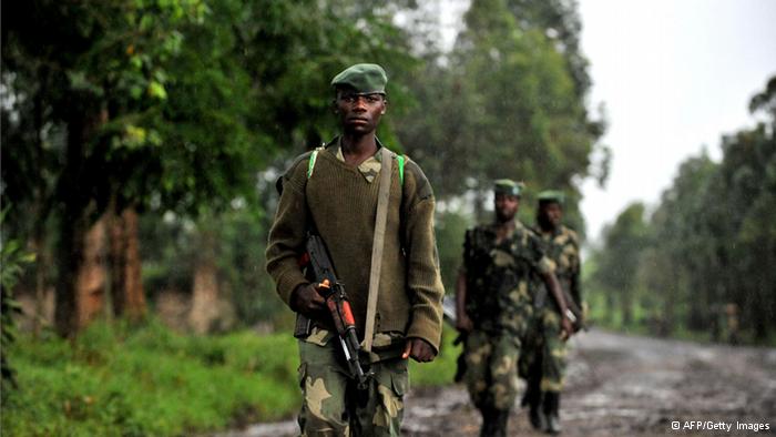 M23 rebel group soldiers patrol on October 17, 2012 in Rangira, near Rutshuru. Two rebel groups active in the Democratic Republic of Congo's restive east, the M23 and FDLR, have formed an alliance and clashed with the country's military, an army spokesman said on October 17. Photo: Junior D. Kannah/AFP/Getty Images