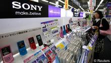 A customer looks at Sony Corp's portable music players displayed at an electronic store in Tokyo 