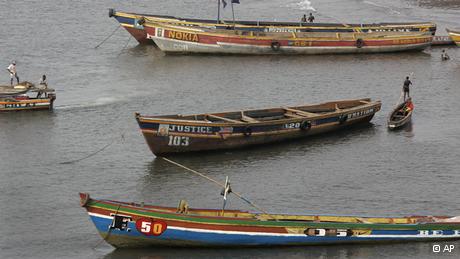 Fishermen and their boats on the shore line at Freetown, Sierra Leone .(ddp images/AP Photo/Schalk van Zuydam)