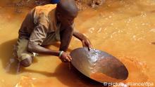 A child in Madagascar sifts for gold