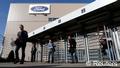 Workers leave the Ford assembly plant in Genk 