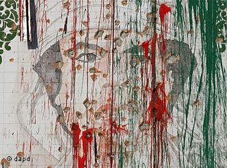A portrait depicting Libya's former ruler Moammar Gadhafi is riddled with bullet marks and vandalized with paint 