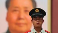 A paramilitary policeman stands by the portrait of Mao Zedong on the Tiananmen Gate in Beijing Sunday Sept. 13, 2009. Photo via Newscom Picture-Alliance