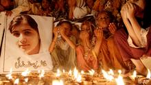 Pakistani children pray for the recovery of 14-year-old schoolgirl Malala Yousufzai, who was shot on Tuesday by the Taliban for speaking out in support of education for women, during a candlelight vigil in Karachi, Pakistan, October 12, 2012. (Photo: Shakil Adil/AP/dapd)