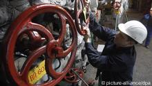 A Ukrainian worker opens a valve at a city heating and electro-power station