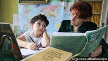 Female tutor teaches a boy during a private English lesson