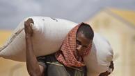 Man carrying sack of food aid