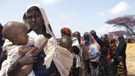Women and children in Somalia line up for food