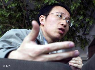 ** FILE ** In this March 31, 2006 file photo, Chinese AIDS activist Hu Jia speaks during an interview at a cafe in Beijing._ The European Parliament gave a jailed Chinese dissident a one-minute standing ovation on Wednesday as it honored him in absentia with its top human rights award. Hu Jia, who chronicled the harassment of other activists in China before getting sentenced to 3 1/2 years in jail last April, was named winner of the 2008 Sakharov Prize. (AP Photo/Ng Han Guan, File)