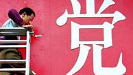 A man works on part of a banner which promotes the 16th Communist Party Congress, in Shanghai Monday, Nov. 11, 2002. The chinese character reads Party. The week-long congress, which ends in Beijing Thursday, will decide China's leadership lineup for the next five years. 