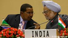 Indian Prime Minister Manmohan Singh (R) listens as Tanzanian President and African Union President Jakaya Mrisho Kikwete speaks during the first India-Africa Forum Summit in New Delhi on April 9, 2008. India sought to deepen strategic and economic ties with resource-rich Africa as it held its first summit meeting with African leaders and sweetened the pot by offering financial help.Indian Premier Manmohan Singh, playing host to the presidents of five African states and senior leaders of nine other countries, announced export tariffs cuts that he said would benefit 34 of Africa's 53 countries. AFP PHOTO/Findlay KEMBER (Photo credit should read FINDLAY KEMBER/AFP/Getty Images) 