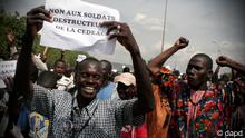 A man carries a sign reading No to the destructive soldiers of ECOWAS as Malians opposed to a military intervention to retake Mali's Islamist-controlled north march in the streets of the capital, Bamako, Mali on Thursday, Oct. 18, 2012. Representatives of the African Union, regional bloc ECOWAS, and the United Nations were due to meet Friday in Bamako to discuss options for a military invention. (AP Photo/Harouna Traore)