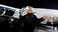 Head the Virgin Group, British, Sir Richard Branson stands in front of SpaceShipTwo during the rocket plane's worldwide debut at an event for dignitaries and future 'astronauts in Mojave, California, USA on 07 December 2009. Virgin Galactic unvieled SpaceShipTwo, on 07 December 2009 after secret development for the past two years. The company plans to sell suborbital space rides for 200,000 US dollars on134,695 euros a ticket, offering passengers two and a half hour-hour flights that include around five minutes of weightlessness. EPA/ANDREW GOMBERT
