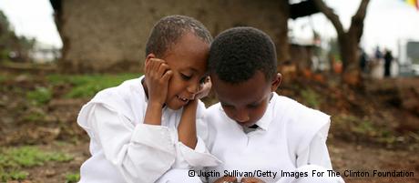 Two boys play with a cellular phone in Ethiopia