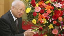 Then Cambodian King Norodom Sihanouk stands beside flowers given by the Chinese government during a meeting with Chinese State Councilor Dai Bingguo (not seen) in Beijing, October 30, 2006. Cambodia's former King Norodom Sihanouk died of natural causes in Beijing, China, early Monday, Xinhua News Agency reported. Picture taken October 30, 2006. REUTERS/China Daily (CHINA - Tags: POLITICS) CHINA OUT. NO COMMERCIAL OR EDITORIAL SALES IN CHINA