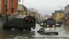 Half-submerged cars on a street in Albania 