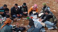 Free Syrian Army fighters eat lunch at Marat Al-Numan
