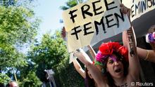 Activists from the women's rights group FEMEN shout slogans during a protest, against the arrest of their fellow Tunisian members, in front of Tunisia's embassy in Madrid June 12, 2013. REUTERS/Juan Medina (SPAIN - Tags: CIVIL UNREST) TEMPLATE OUT