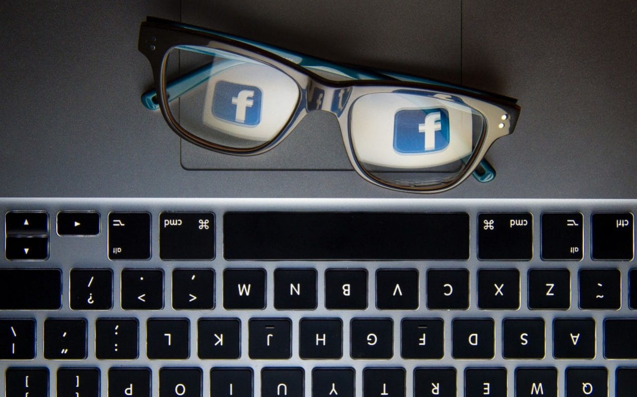 Facebook's logo reflected in a pair of glasses