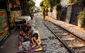 Children take a nap in the shade by the train tracks in the Khlong Toei neighborhood on May 01, 2024 in Bangkok, Thailand